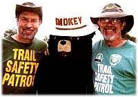 Patrol members, on either side of Smokey Bear, wear two styles of VHP shirts
